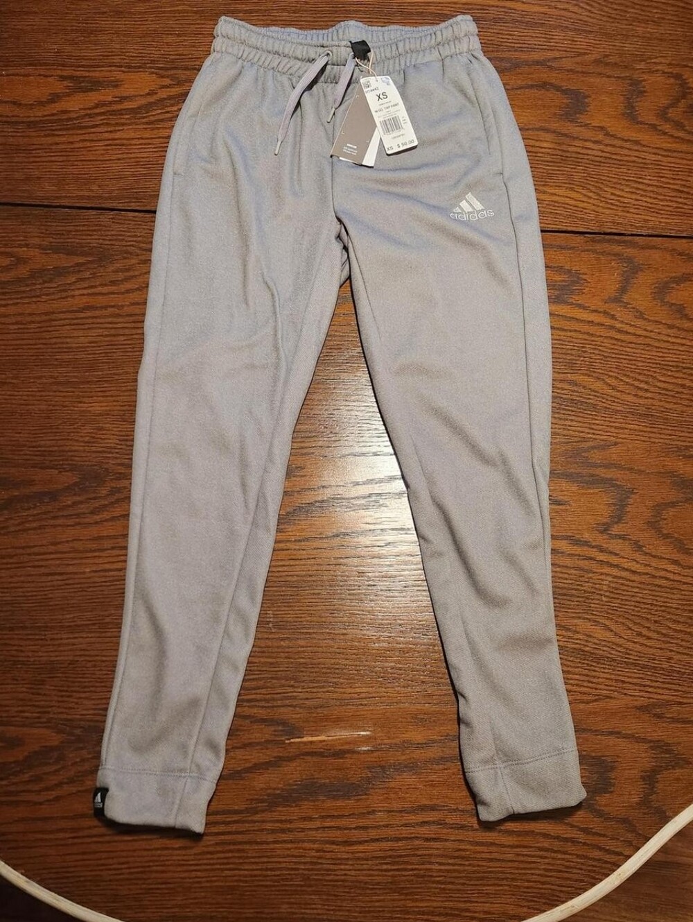 Gray Adidas joggers with drawstring waist and tapered fit
